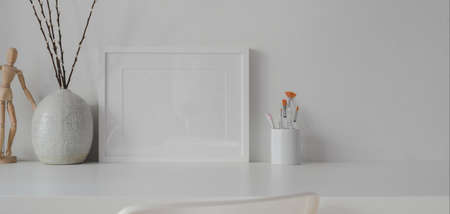 Minimal room with mock up frame with ceramic decorations on white table with white wall backgroundの写真素材