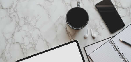 Top view of modern workspace with tablet and office supplies on marble table backgroundの写真素材