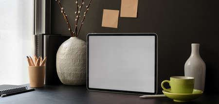 Trendy office room with blank screen digital tablet with office supplies and decorationsの写真素材
