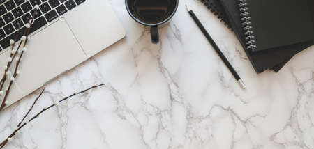 Top view of modern workplace with laptop computer and office supplies on marble table backgroundの写真素材