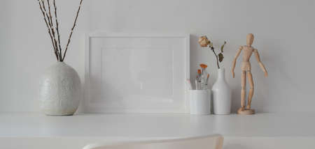 Minimal room with mock up frame with ceramic decorations on white table with white wall backgroundの写真素材