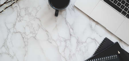 Top view of modern workplace with laptop computer and office supplies on marble table backgroundの写真素材