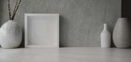 Minimal workspace with mock up frame and ceramic vase decorations with copy spaceの写真素材