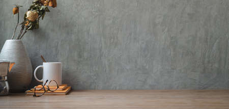 Vintage workspace with dry roses with office supplies and copy space on wooden tableの写真素材