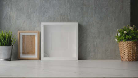 Modern office room with mock up frame and decorations with copy space on marble deskの写真素材