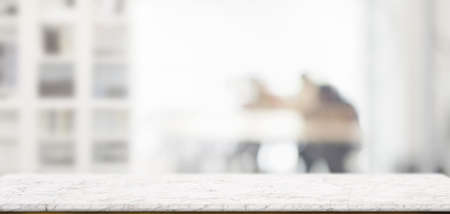 Close-up view of empty wooden table and copy space with blurred living room in the background