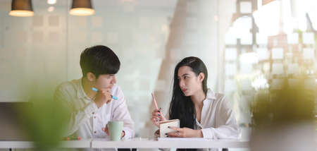 Cropped shot of young professional designer team discussing the current project together in modern office roomの写真素材