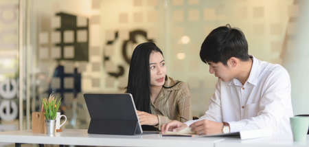 Young successful business people discussing the strategy together in modern office room