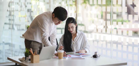 Cropped shot of young hard-working designer team planing their project together in modern workplaceの写真素材