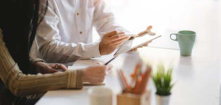 Cropped shot of young designer team working on their project together in modern office roomの写真素材