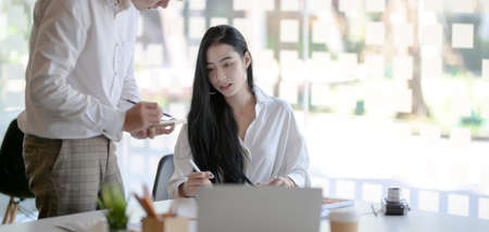 Cropped shot of young hard-working designer team planning their project together in modern workplaceの写真素材