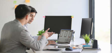 Group of professional UX graphic designer working on smartphone template together in modern office roomの写真素材