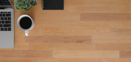 Overhead shot of comfortable workplace with copy space and office supplies on wooden table...