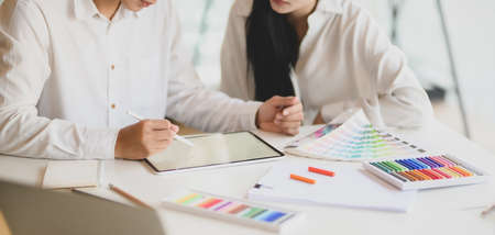 Cropped shot of young graphic designer team working on their concept together in modern office room