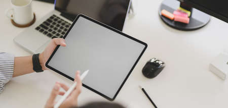 Cropped shot of young professional UX web developer working on smartphone template together