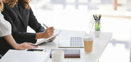Cropped shot of professional businesswomen team working on company strategy together with tabletの写真素材