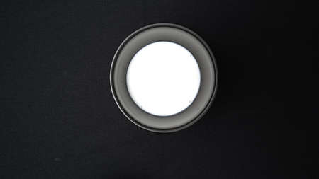 Top view of coconut milk in blow on black desk background, Thai food ingredients with copy space