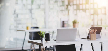 Modern office room with office supplies on table with office environment in the backgroundの写真素材