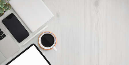 Close-up view of trendy workplace with blank screen tablet, office supplies and copy space on white...
