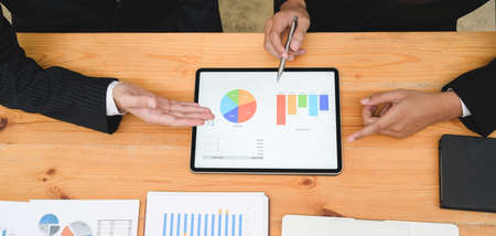 Cropped shot of young professional business team preparing the project with charts and graphs