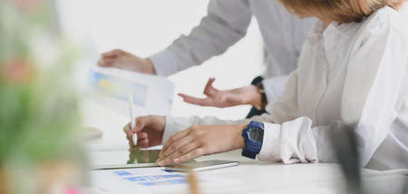 Cropped shot of young business people discussing on the project together in modern office room 