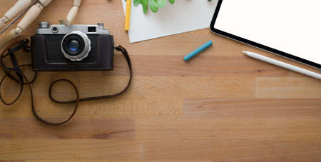 Top view of comfortable designer workplace with painting tools and office supplies on wooden table with copy space の写真素材