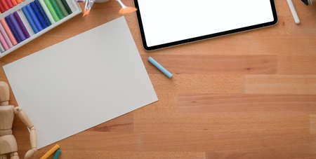 Top view of modern designer workplace with sketch paper and mock-up tablet on wooden table with copy...