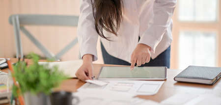 Cropped shot of young professional ux web developer working on her project while using digital...