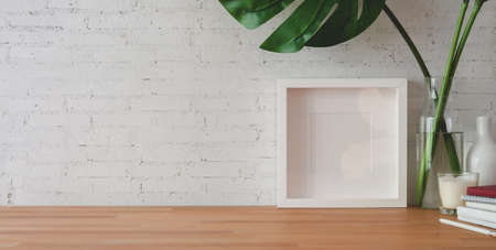 Cropped shot of comfortable workplace with office supplies and copy space on wooden table and brick...