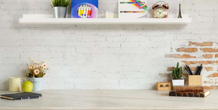 Cropped shot of comfortable designer workplace with office supplies and copy space on marble desk and brick wall background の写真素材