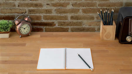 Close up view of modern workspace with note book, computer and office supplies on wooden table...