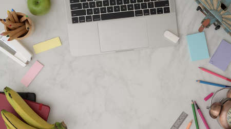 Top view of professional artist workspace with copy space, laptop, stationery, office supplies,...
