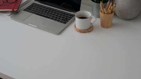 Cropped shot of practical artist workplace with laptop, copy space, coloured pencils and coffee cup...