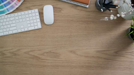Top view of modern rustic workspace with computer device, office supplies and decorations on wooden...