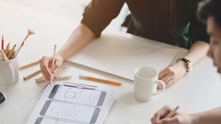 Close up view of team application developer concentrating on UI project  in modern meeting room 