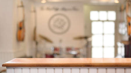 Close up view of interior music shop with copy space on wooden counter and blurred backgroundの写真素材