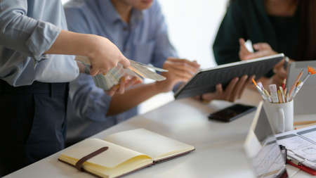Close-up view of young UI graphic designer team planing their smartphone template together with laptop in office room の写真素材