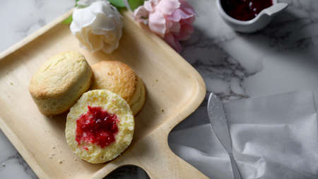 Cropped shot of Traditional English scones with strawberry jam on marble deskの写真素材