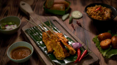 Cropped shot of Thai traditional street food with pork satay with peanut sauce and Thai appetisers...