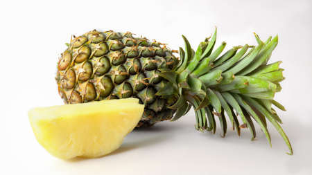 Close up view of whole and sliced ripe pineapple, tropical fruit isolated on white background の写真素材