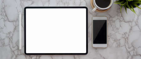 Top view of modern workspace with blank screen tablet , smartphone and coffee cup on marble table 