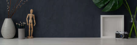 Cropped shot of modern workspace with camera, stationery, decorations and copy space on marble deskの写真素材