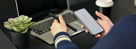 Cropped shot of businesswoman working with digital tablet while reading information on mock-up...