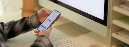 CHIANG MAI, THAILAND - MAY 11, 2020 : businesswoman looking on iPhone with LinkedIn screen. LinkedIn is professional communityのeditorial素材