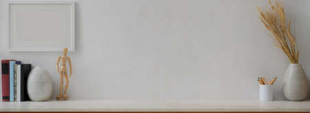 Close up view of contemporary home interior design with books, decorations, stationery and copy space on marble table の写真素材