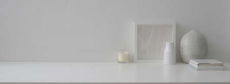 Close up view of minimal home interior design with copy space, notebooks, candle and decorations on...