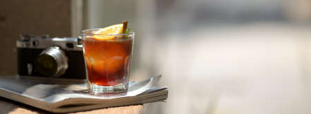 Close up view of a glass of orange espresso : espresso shot mixed with orange juice on wooden deskの写真素材