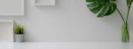Close up view of minimal home interior design with copy space, mock-up frames and plant vases on...