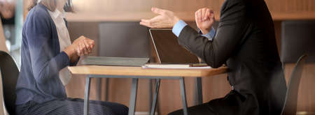 Cropped shot of male financial adviser consulting with female customer in office room
