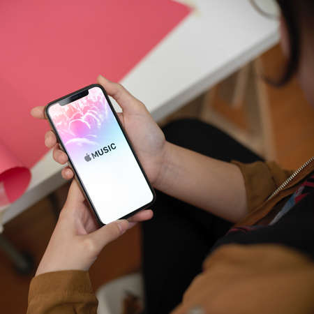 CHIANG MAI, THAILAND - MAY 28, 2020 : female holding iPhone with Apple Music screen. Apple Music is streaming music serviceのeditorial素材